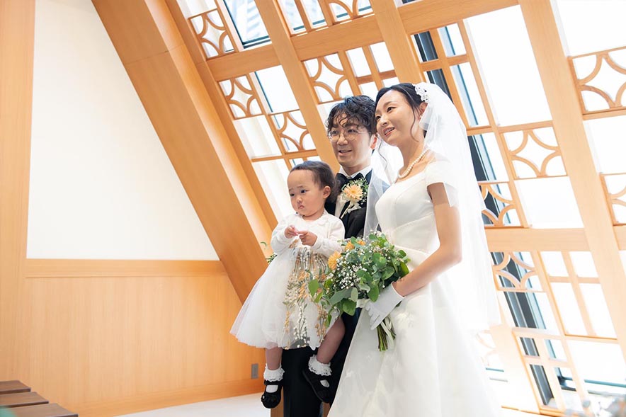 チャペルに立つ子供と新郎新婦